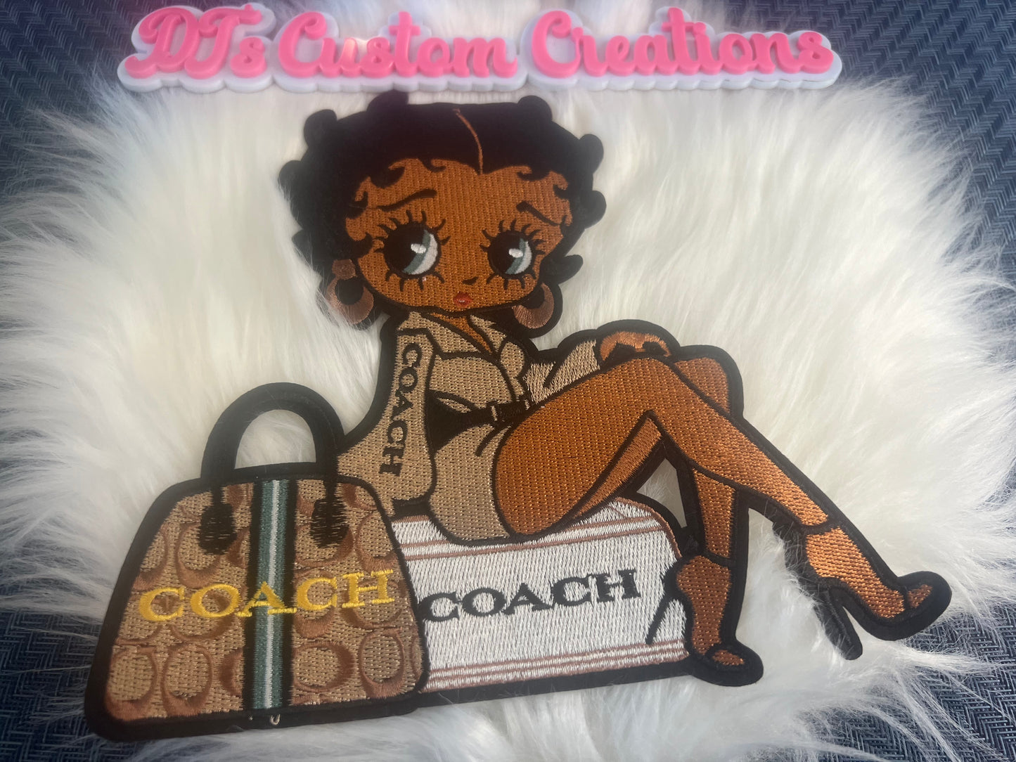 Tan Coach Betty sitting on luggage