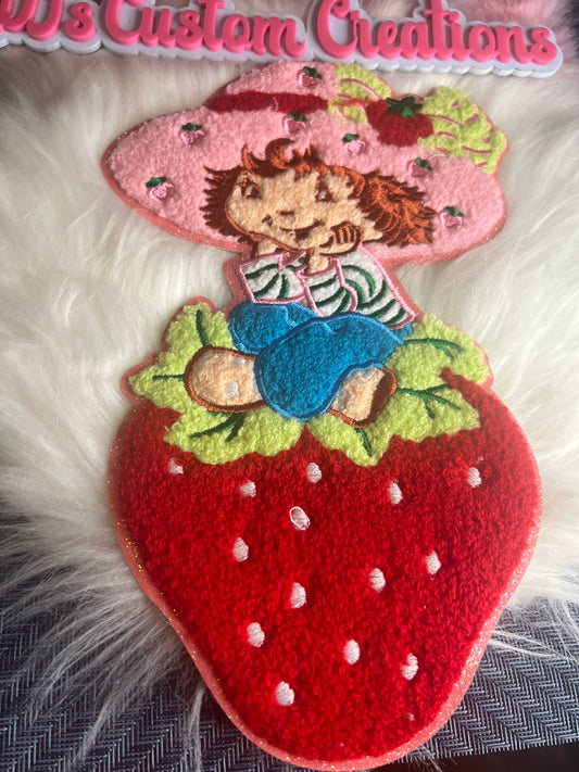 Strawberry shortcake sitting on strawberry